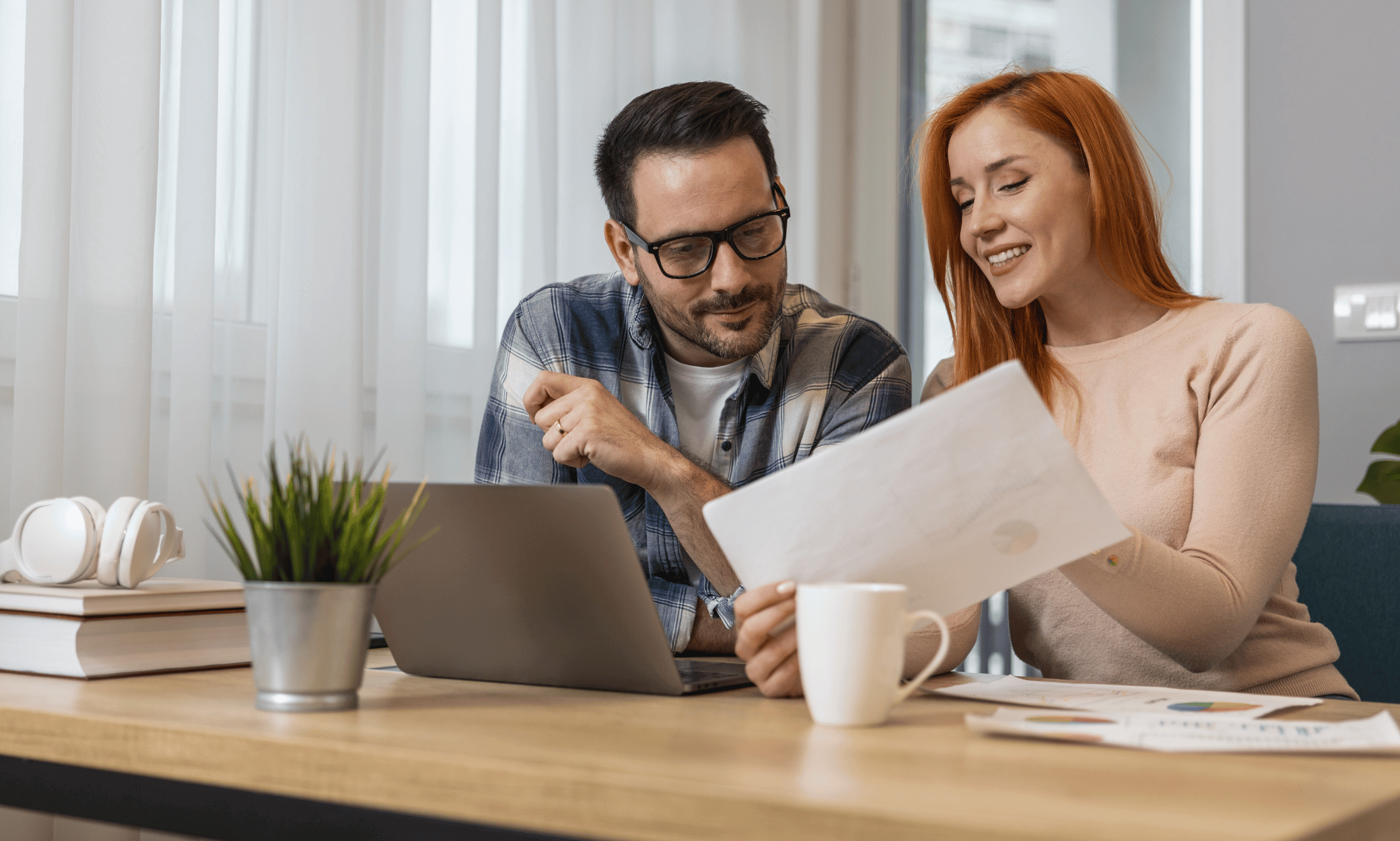 Two people looking at a paper