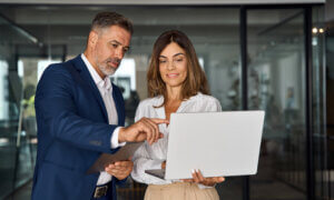 Two people discussing work on the computer.