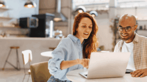 Two people looking at a laptop