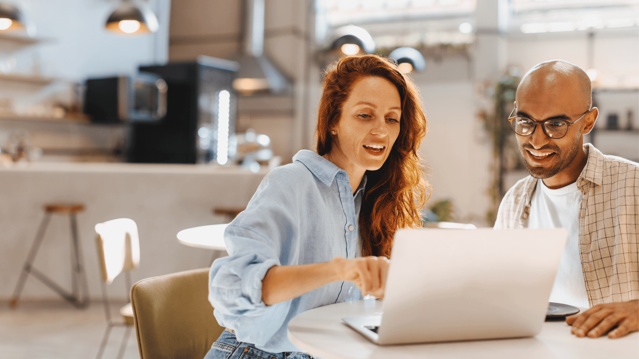 Two people looking at a laptop